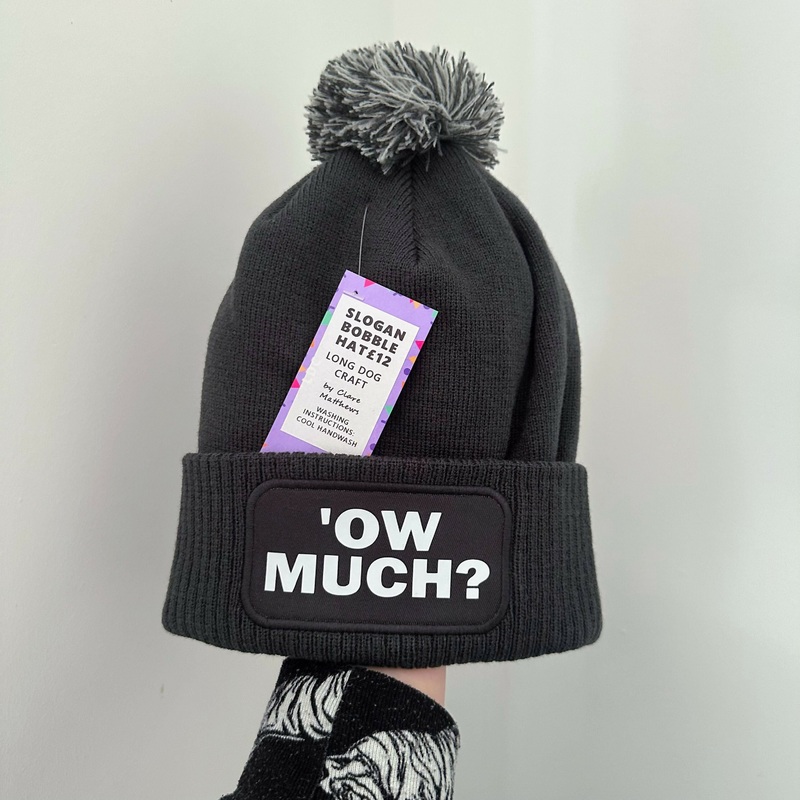 Ow Much Cuffed Rectangular Patch Bobble Hat