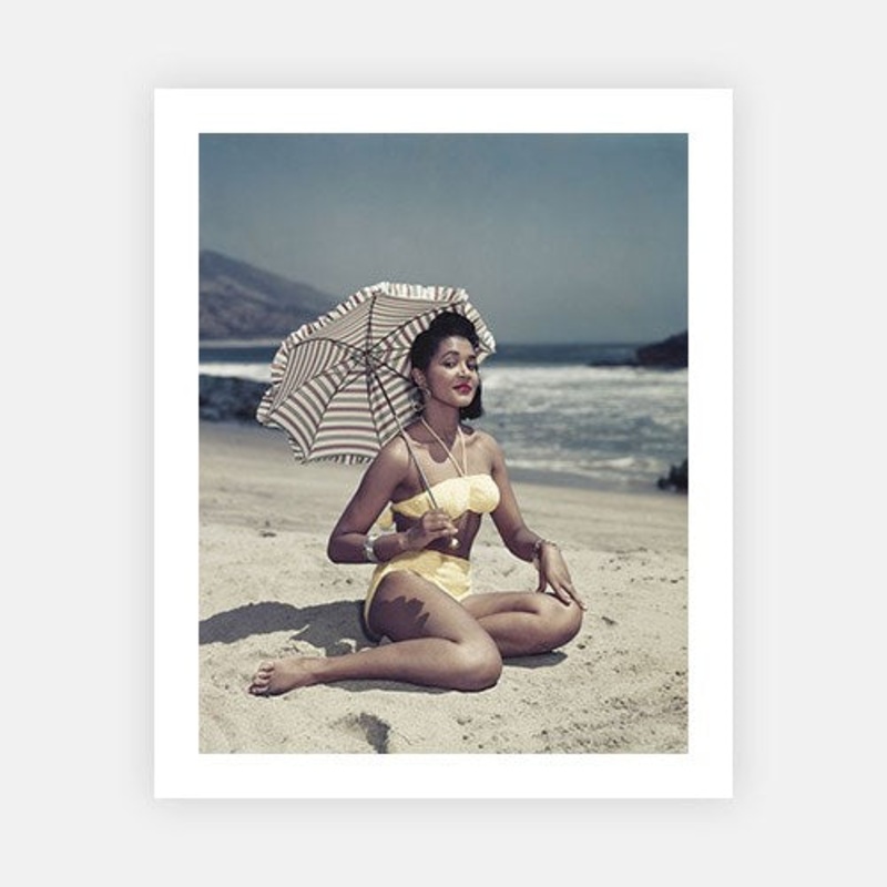 Woman on Beach Holding Umbrella